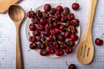 Top view of a plate of cherries.