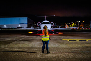 SOUTHEND-ON-SEA, ENGLAND &ndash; OCTOBER 26, 2025: Loganair operates its inaugural flight LM028 from Southampton (SOU) to Manchester (MAN) using an Embraer regional jet; ground crew marshalling signals STOP