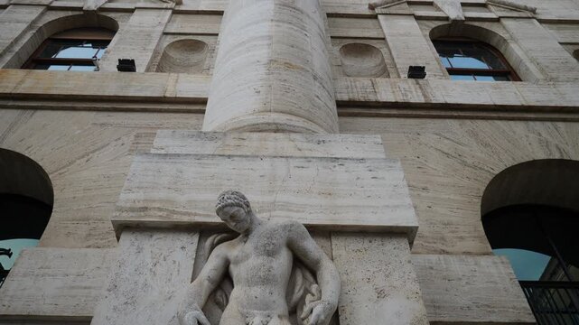 Sculpture on Midnight palace seat of the Italian stock exchange in Milan, Italy