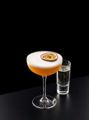 vertical pornstar martini cocktail with prosecco shot on black background