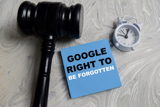 Concept of google right to be forgotten write on sticky notes isolated on Wooden Table. Representing data privacy, digital rights and court decision