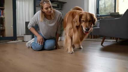 Medium shot of user gently cleaning the sensor area of a petfriendly robotic vacuum to enhance performance around pet hair