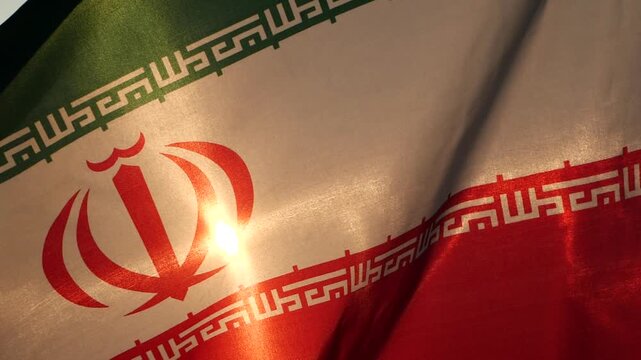 Close up Iran national flag waving with sunlight through fabric texture, expressing national identity, culture, patriotism as a clean political background for global design use