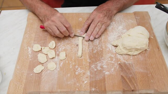 Preparing orecchiette pasta on a cutting board for Puglia region food