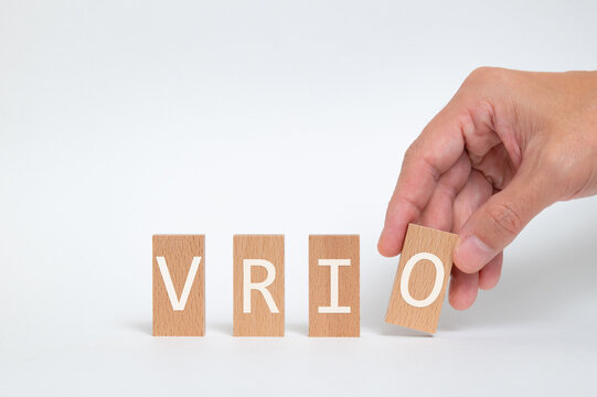 There is wood block with the word VRIO. It is an abbreviation for Value, Rarity, Inimitability, Organization as eye-catching image.