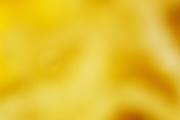 Blurry view of golden oil splash as background