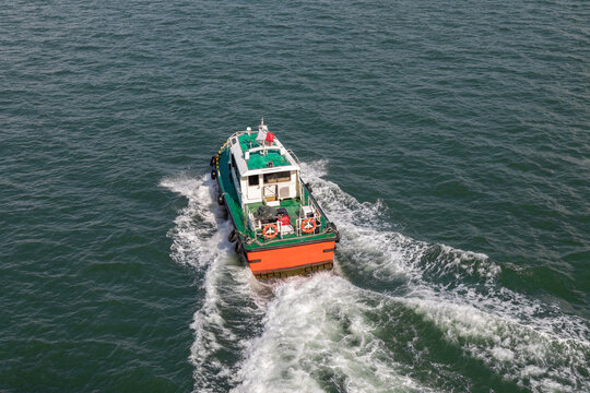 Pilot Boat Motoring Away from Cruise Ship in the Harbor of Penang, Malaysia