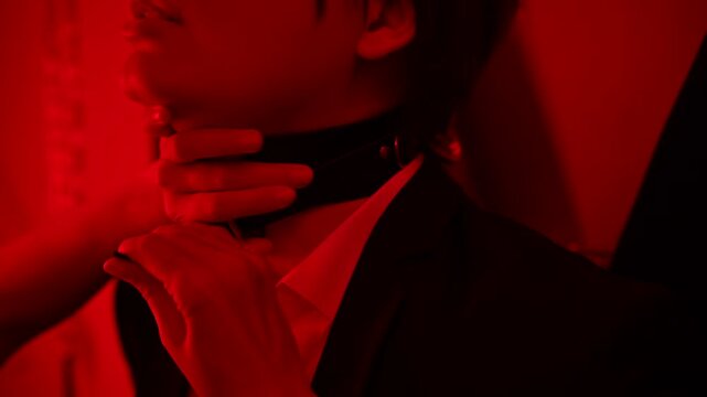 A woman chains her partner to a BDSM cross. Role-playing games.