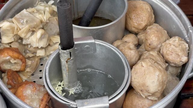 Indonesian traditional street food meatball or bakso with dumplings and tofu in a steamer