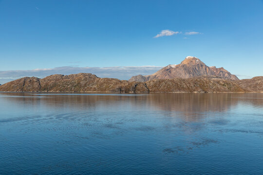 A Snow-Capped Mountain Near Ivittuut, Greenland Reflected in the Calm Labrador Sea on a Bright Blue Autumn Day