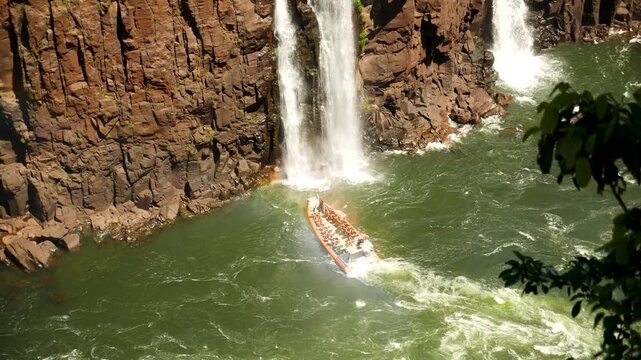 Speed boat rides under Iguazu Falls in Argentina - Brasil Border is one of the Natural Seven Wonders of the World and an UNESCO World Heritage Site. High quality 4k footage