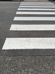Obraz premium White pedestrian crossing stripes on road