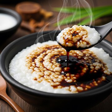 Bubur Sumsum, Indonesian rice flour porridge with sweet palm sugar sauce in a black bowl