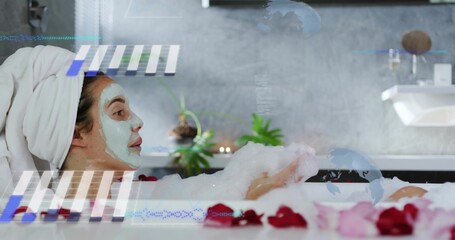 Soaking woman with towel holding foam in bathtub at spa wearing face mask and digital overlays