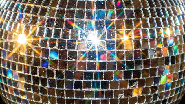 Disco ball mirror mosaic texture background with light reflections.