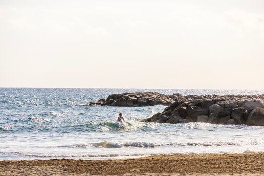 swimmer in the waves at the ocean
