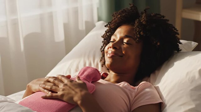 Woman resting with hot water bottle