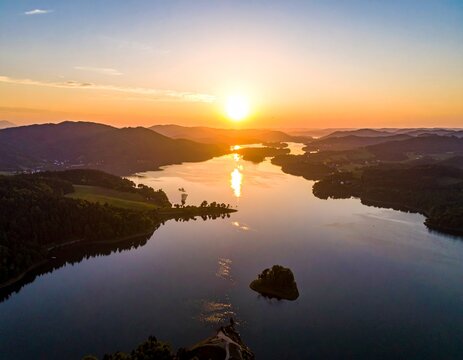 Sunset over Serene Lake and Rolling Hills