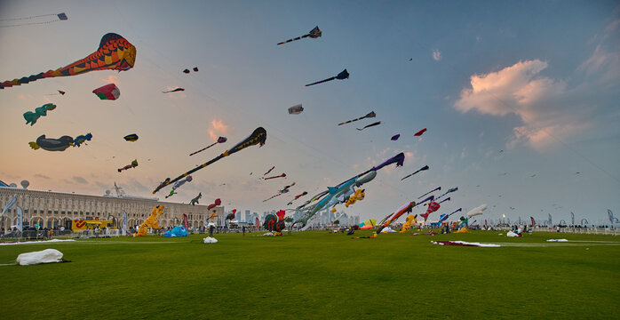 Doha, Qatar - January 20 2026: Qatar Kite Festival 2026 in Old Doha port (Mina District) sunset shot showing spectacular showcase of colorful kites