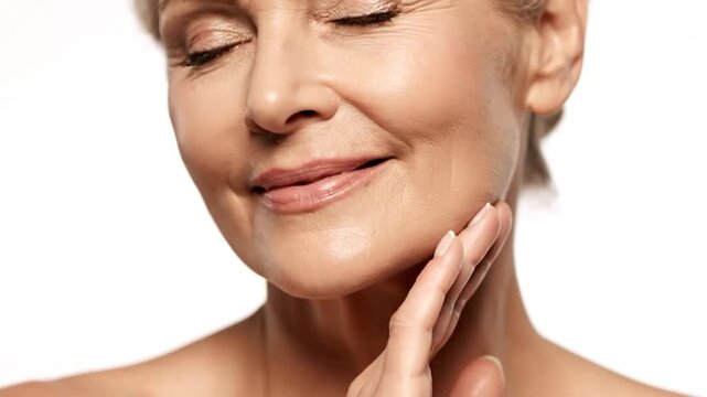 Close-up of a woman's face, focusing on her chin and neck, with her finger touching her chin