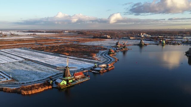 Aerial winter view of the Zaanstreek windmills at Zaanse Schans, showing historic polder mills, snow landscape, and Dutch cultural heritage.