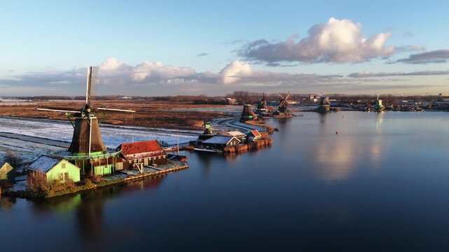 Aerial winter view of the Zaanstreek windmills at Zaanse Schans, showing historic polder mills, snow landscape, and Dutch cultural heritage.