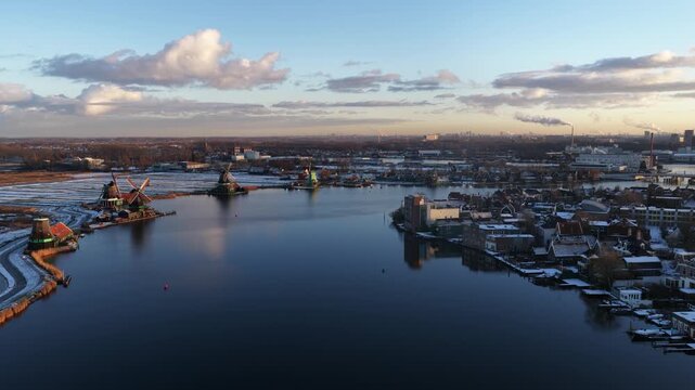 Aerial winter view of the Zaanstreek windmills at Zaanse Schans, showing historic polder mills, snow landscape, and Dutch cultural heritage.