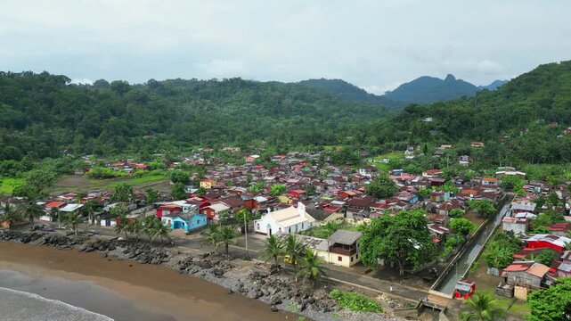 Aerial view from a taxi van at a coastal road at Ribeira Afonso,Sao Tome,Africa. Backwards circular drone shot.