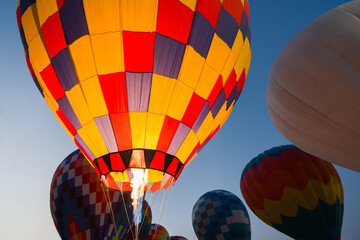 colorful hot air balloons glowing against sky