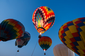 colorful hot air balloons glowing against sky