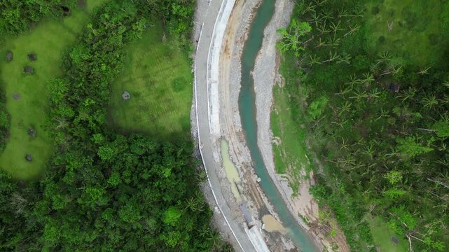 River Along The Verdant Trees In Rural Area Of Hicming In Virac, Catanduanes. - aerial top down shot
