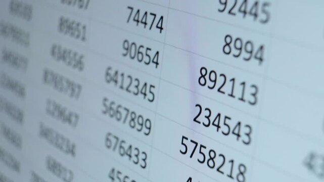 Analyzing financial data on a digital desktop computer screen displaying rows of numbers for business analytics