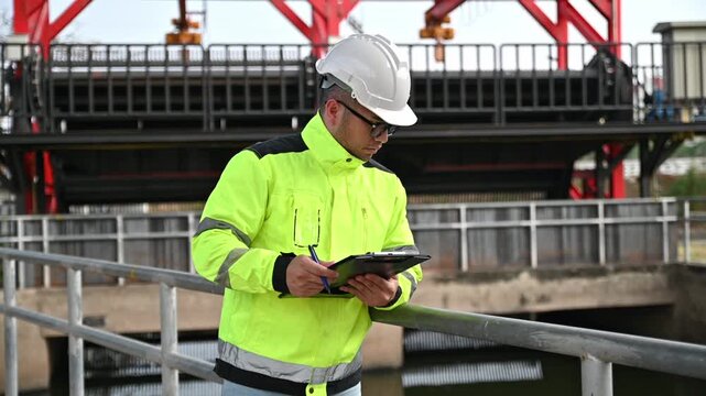 A specialist engineer is inspecting for defects in the wastewater treatment system.