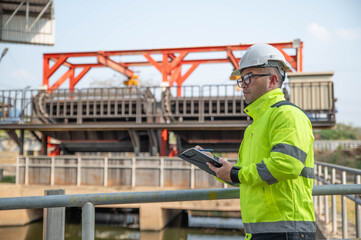 A specialist inspector is checking the water diversion system of the wastewater treatment plant.