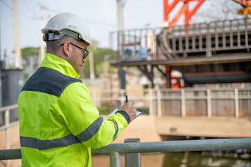 A specialist inspector is diligently examining the overall operation of the wastewater treatment plant.