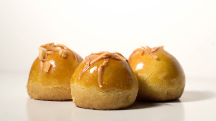 Detail photo of nastar cake filled with pineapple cream with sliced ​​cheese topping isolated on white background