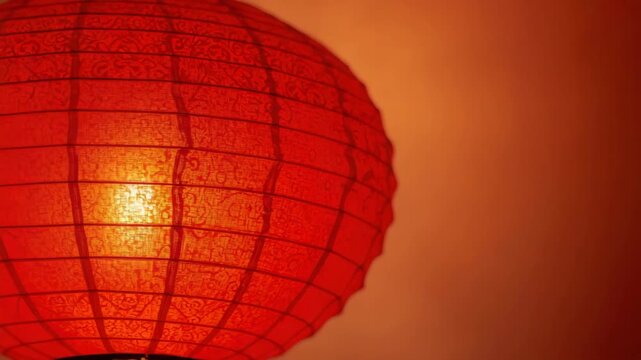 Red paper lantern glowing warm light with decorative textured pattern, festive cozy glow