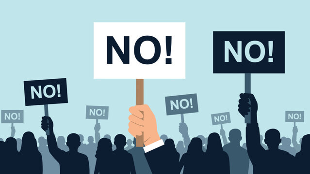 Large group of people holding up signs that say no during a protest or demonstration expressing disagreement and public opposition.