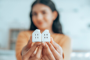 Happy Asian woman holding house. Concept property real estate and mortgage