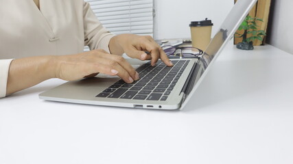 businesswoman working use laptop in office for discussing documents and ideas , with soft focus, vintage tone
