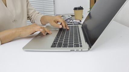 businesswoman working use laptop in office for discussing documents and ideas , with soft focus, vintage tone