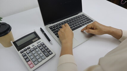 businesswoman working use laptop in office for discussing documents and ideas , with soft focus, vintage tone