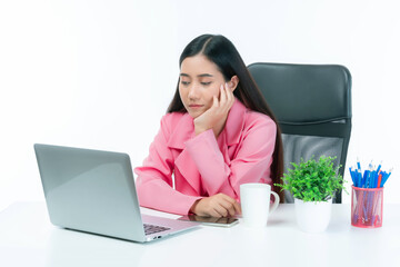 Thoughtful young Asian businesswoman in pink blazer sitting at desk with laptop computer, resting head on hand with tired serious expression, modern office workspace lifestyle concept isolated on whit