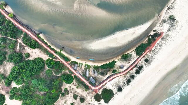 Scenic aerial drone shot of Konkan coast, river merging into ocean, tropical trees along the beach, calm sea waves, golden sunlight, tranquil tropical landscape, natural beauty, serene environment, we