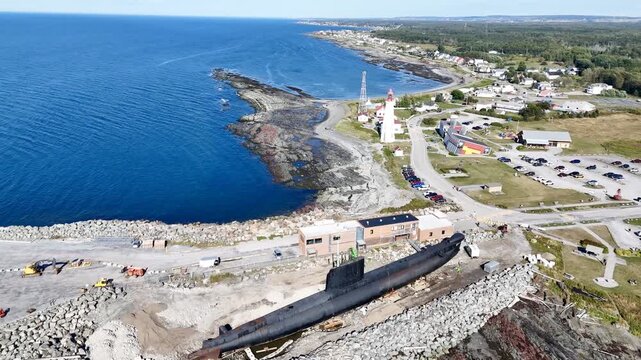 Aerial view of Pointe au Pere lighthouse near Rimouski on rocky coastline, Quebec, Canada, summer daylight. g.