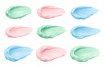 Pastel cosmetic cream swatches. Pink, blue, and green beauty product smears showing smooth texture on transparent background