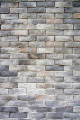 Fototapeta premium High-quality texture of a dark grey brick wall with weathered vintage finish. This industrial loft style masonry background is perfect for interior design, architectural rendering, and web wallpaper.