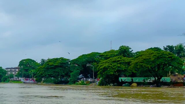 Eagle bird circles above Surma River as drone pans past Sylhet&rsquo;s vibrant riverbank in Bangladesh