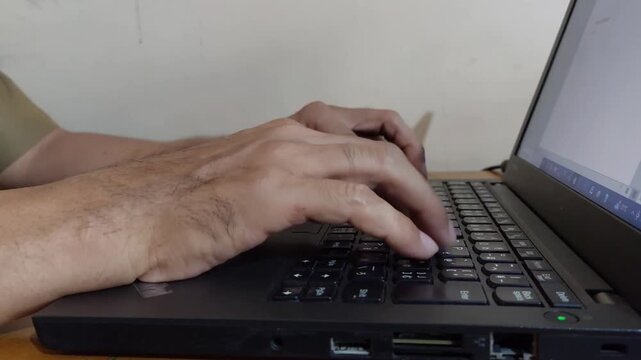 close up of a man using a laptop
