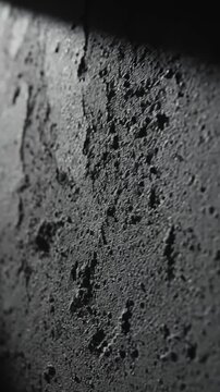 Abstract Close-Up of a Textured Concrete Surface with Dramatic Lighting and Shadow Play